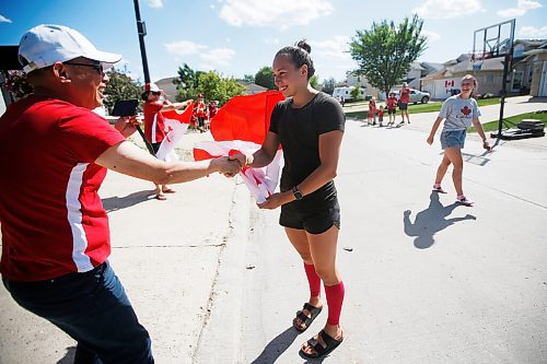 JOHN WOODS / WINNIPEG FREE PRESS
Winnipeg swimmer Kelsey Wog is wished well by her neighbour Gary Liu as she is greeted by her neighbours Thursday, June 17, 2021. Residents of Wogs street gathered at the end of their driveways to wish her well as she heads off to the national swimming trials. 

Reporter: Sawatzki