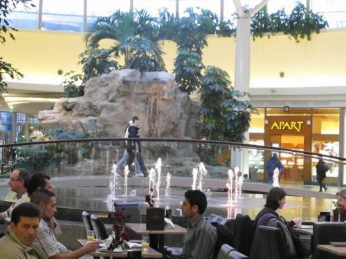 Shoppers cross bridge over water feature in Selisia Centre mall past diners at indoor patio.  ¤  Gerald Flood  Comment Editor  Winnipeg Free Press
