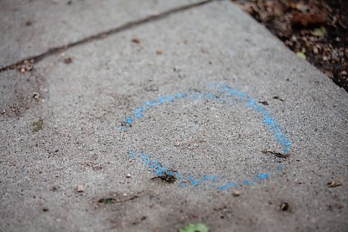 Daniel Crump / Winnipeg Free Press. Blue chalk marks a spot where evidence was found on a Burrows avenue sidewalk where a 12-year-old youth was fatally stabbed Friday evening. June 19, 2021.