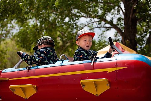 Daniel Crump / Winnipeg Free Press. Damian (right) and his brother Ian enjoy a ride at Tinkertown. The amusement park reopened on Saturday after a loosening of public health orders. June 19, 2021.
