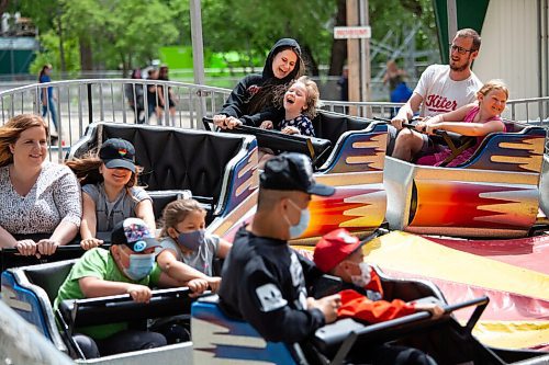 Daniel Crump / Winnipeg Free Press. Nicole Capri (top centre) and daughter Laina Capri, age 5, ride a rollercoaster at Tinkertown. The amusement park reopened on Saturday after a loosening of public health orders. June 19, 2021.