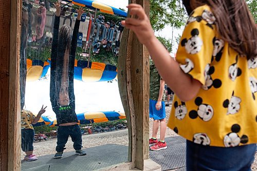 Daniel Crump / Winnipeg Free Press. Nicolas Rueda (reflection), age 10, and Sophia (right), age 8, play with novelty mirrors at Tinkertown. The amusement park reopened on Saturday after a loosening of public health orders. June 19, 2021.