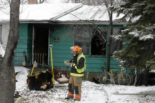 MIKE.DEAL@FREEPRESS.MB.CA 100324 - Wednesday, March 24th, 2010 A lone occupant of the house at 520 Hazel Dell Ave. was taken to hospital with unknown injuries from a fire according to Garry Pinette a Fire Chief (not in photo) at the scene. Fire Safety Officer inspect damage. MIKE DEAL / WINNIPEG FREE PRESS