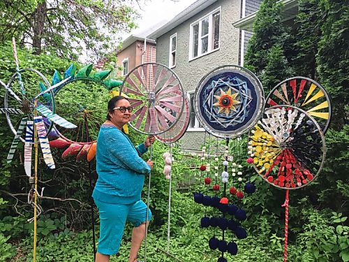 Canstar Community News West End artis Moneca Sinclaire uses plastic trash and recyclables that other artists might shun in her art. Red, yellow and black pop-bottle lids pick out the colour of the medicine wheel on one sculpture, and the windmill-style blades of another are fashioned from cut-down pop bottles.