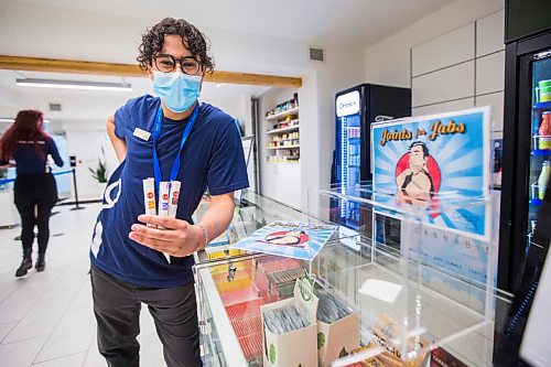 MIKAELA MACKENZIE / WINNIPEG FREE PRESS

Cannabis specialist Adam El-Gabalawy holds a few joints in front of the entry box for the new Joints for Jabs pro-vaccination program at the Osborne Delta 9 Cannabis Store in Winnipeg on Monday, June 21, 2021. For Temur story.
Winnipeg Free Press 2021.