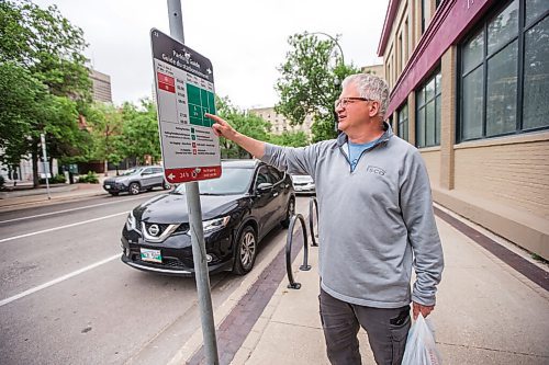 MIKAELA MACKENZIE / WINNIPEG FREE PRESS

Hassan Hawash looks at a parking guide sign in the Exchange District in Winnipeg on Monday, June 21, 2021. For Joyanne story.
Winnipeg Free Press 2021.