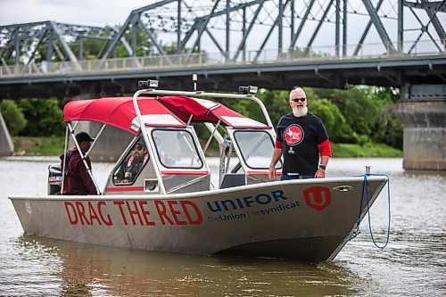 MIKAELA MACKENZIE / WINNIPEG FREE PRESS

Mitch Bourbonniere stands at the helm of the boat on the 2021 launch of Drag the Red, a search for missing and murdered, with a new boat (donated by Unifor) on the Red River near the Redwood Bridge in Winnipeg on Monday, June 21, 2021. Standup.
Winnipeg Free Press 2021.