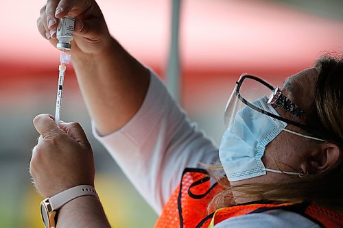 JOHN WOODS / WINNIPEG FREE PRESS
Carol Moore, a nurse at St Amant, draws some vaccine at Manitobas first drive-in vaccination clinic at St Amant Centre Monday, June 21, 2021. 

Reporter: Abas