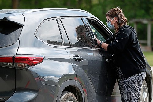 JOHN WOODS / WINNIPEG FREE PRESS
Sarah Mankelow, a nurse and director of health and transition services, inoculates a passenger at Manitobas first drive-in vaccination clinic at St Amant Centre Monday, June 21, 2021. 

Reporter: Abas