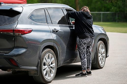 JOHN WOODS / WINNIPEG FREE PRESS
Sarah Mankelow, a nurse and director of health and transition services, inoculates a passenger at Manitobas first drive-in vaccination clinic at St Amant Centre Monday, June 21, 2021. 

Reporter: Abas