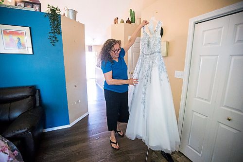 MIKAELA MACKENZIE / WINNIPEG FREE PRESS

Rhonda holds her daughter's grad dress at her home in Winnipeg on Tuesday, June 22, 2021. For Jen Zoratti story.
Winnipeg Free Press 2021.