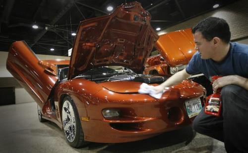 MIKE.DEAL@FREEPRESS.MB.CA 100325 - Thursday, March 25th, 2010 Chris Toffen wipes down his 2002 Trans Am WS6 that will be on display at the World of Wheels Auto Show at the convention this weekend. MIKE DEAL / WINNIPEG FREE PRESS