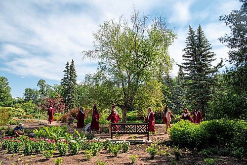 ALEX LUPUL / WINNIPEG FREE PRESS  

Westwood Collegiate graduates walk past an employee at the English Garden in Winnipeg on Wednesday, June 23, 2021.