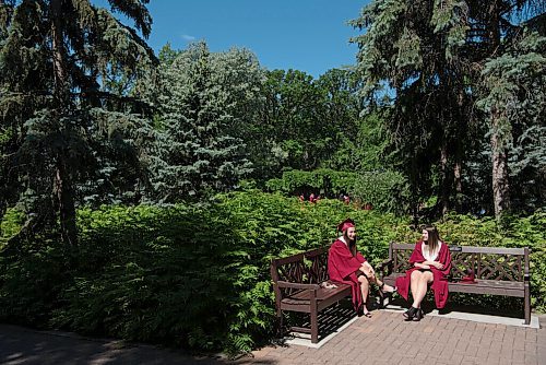 ALEX LUPUL / WINNIPEG FREE PRESS  

Westwood Collegiate graduates Laura McKay and Kara Macrae sit together at the Leo Mol Sculpture Garden in Winnipeg on Wednesday, June 23, 2021.