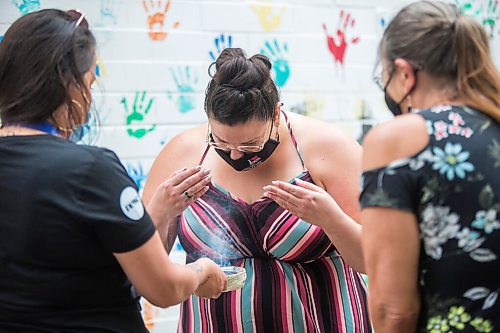 MIKAELA MACKENZIE / WINNIPEG FREE PRESS

Brittany Anderson smudges after getting her shot at a pop-up vaccine clinic at the North End Women's Centre in Winnipeg on Wednesday, June 23, 2021. Standup.
Winnipeg Free Press 2021.