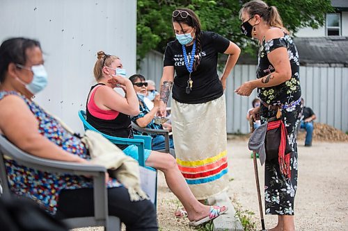 MIKAELA MACKENZIE / WINNIPEG FREE PRESS

Kathleen LeClair gets a smudge from Aja Oliver (centre) and Val Vint (right) while in line at a pop-up vaccine clinic at the North End Women's Centre in Winnipeg on Wednesday, June 23, 2021. Standup.
Winnipeg Free Press 2021.