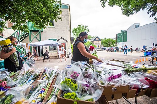 MIKAELA MACKENZIE / WINNIPEG FREE PRESS

Tina Chartrand (centre) and Colleen Nechtvatal (left) pick up some flowers after getting their Moderna shots at a pop-up vaccine clinic at the North End Women's Centre in Winnipeg on Wednesday, June 23, 2021. Standup.
Winnipeg Free Press 2021.