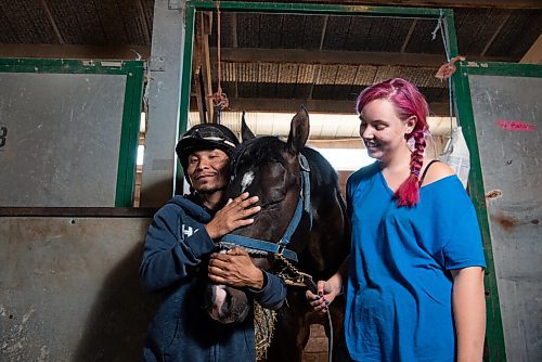 ALEX LUPUL / WINNIPEG FREE PRESS  

Jockey, Jorge Carreño, and Groomer, Charlotte Johnston, pose for a portrait with racehorse Shootin Money on Thursday, June 24, 2021.