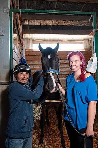 ALEX LUPUL / WINNIPEG FREE PRESS  

Jockey, Jorge Carreño, and Groomer, Charlotte Johnston, pose for a portrait with racehorse Shootin Money on Thursday, June 24, 2021.