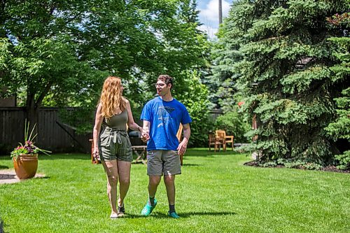 MIKAELA MACKENZIE / WINNIPEG FREE PRESS

Karla Berbrayer and her son, Micah Kraut, pose for a photo in Karla's backyard in Winnipeg on Thursday, June 24, 2021. She's unhappy that the reopening plan doesn't include day centres for people like him. For Malak story.
Winnipeg Free Press 2021.