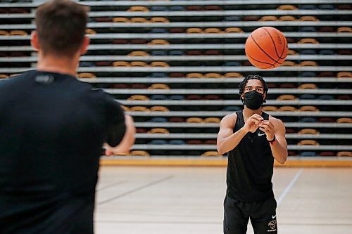 JOHN WOODS / WINNIPEG FREE PRESS
Keiran Zziwa, right, a U of MB Bison basketball player, throws some baskets with coach Kirby Schepp at the university in Winnipeg Wednesday, June 23, 2021. Zziwa is heading to Morocco to play for Uganda at the Afro Basketball qualifier.

Reporter: Sawatzky