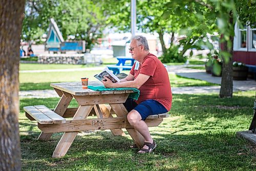 MIKAELA MACKENZIE / WINNIPEG FREE PRESS

Resident John Moore reads a book near the beach in Gimli on Friday, June 25, 2021. For Ben Waldman story.
Winnipeg Free Press 2021.