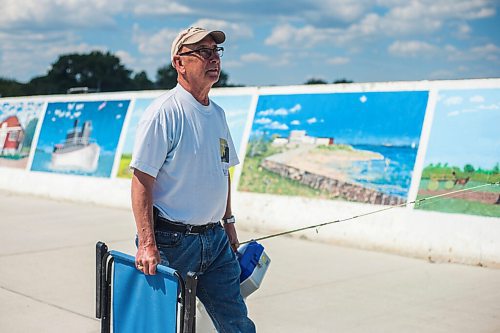 MIKAELA MACKENZIE / WINNIPEG FREE PRESS

Jim Krokosh walks down the pier to do some fishing in Gimli on Friday, June 25, 2021. For Ben Waldman story.
Winnipeg Free Press 2021.