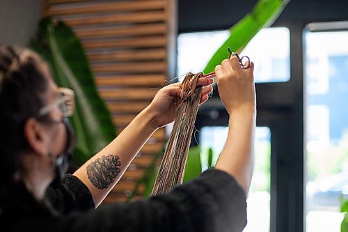 Daniel Crump / Winnipeg Free Press. A stylist cuts a clients hair at Prep Hair on Lilac Street. The hair salon is once again open for business as of Saturday, after the latest easing of pandemic restrictions. June 26, 2021.