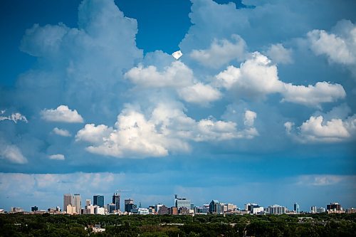 Daniel Crump / Winnipeg Free Press. Ominous clouds hang over downtown Winnipeg, seen looking east from Westview Park. Storms have prompted weather warnings for parts of Southern Manitoba Saturday evening. June 26, 2021.