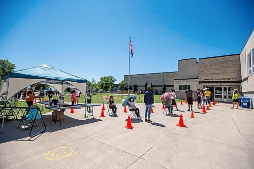 MIKAELA MACKENZIE / WINNIPEG FREE PRESS

Folks line up to get their shots at a pop-up vaccine clinic at Elwick Community School in Winnipeg on Monday, June 28, 2021. The site, which hoped to reach community members who might not otherwise easily be able to get their vaccine, had given out 123 of 150 Pfizer doses by noon. Standup.
Winnipeg Free Press 2021.