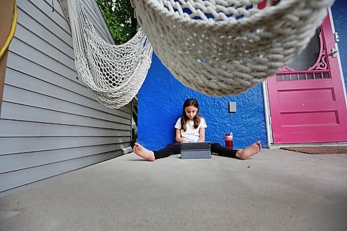 RUTH BONNEVILLE / WINNIPEG FREE PRESS

49.8 - Paynes Remote schooling 

Emby Blum-Payne sits on her front porch with her iPad online with her class as she  finishes her final day of Grade 3 in remote learning.  On this particular morning, Emby wasn't her usual chatty, energetic and rambunctious self.  Instead, she mostly sat quietly by herself watching a movie.  
  
The Paynes have been doing remote schooling this past year because they have a grandparent in the home who is high-risk. 
Krystal Payne, mom of  Grade 3 daughter Emby Blum-Payne, consulted with a child psychologist during the year because of their worries about Emby's wellbeing. Being an only child and chatterbox, the pandemic has been tough on her. She gets easily frustrated with online school, her mother Krystal says. 

Reporter - Maggie

JUNE 26, 2021