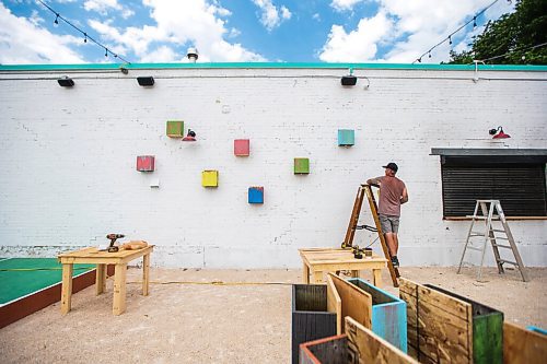 MIKAELA MACKENZIE / WINNIPEG FREE PRESS

FOR BEN SIGURDSON STORY --- Darren Lannoo puts up planter boxes at The Garden at 955 Portage Avenue in Winnipeg on Wednesday, June 30, 2021. The former parking lot, now converted to a new outdoor beer garden, is opening tomorrow (July 1st). 
Winnipeg Free Press 2021.