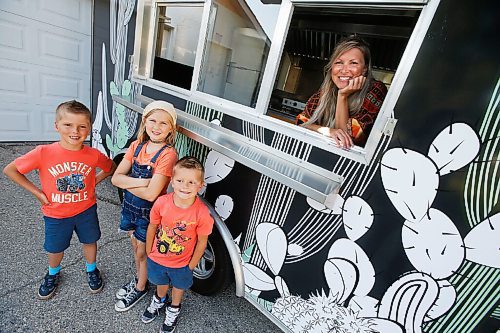 JOHN WOODS / WINNIPEG FREE PRESS
Erin Popoff, a former WestJet pilot laid off because of the pandemic, is photographed with her children Kodiak, 5, Makeiff, 7, and Olive, 9, and her new food truck trailer, Poacht, outside her home in Winnipeg Wednesday, June 30, 2021. Popoff launched the pandemic pivot small business to make up for being let go by WestJet.

Reporter: Durrani