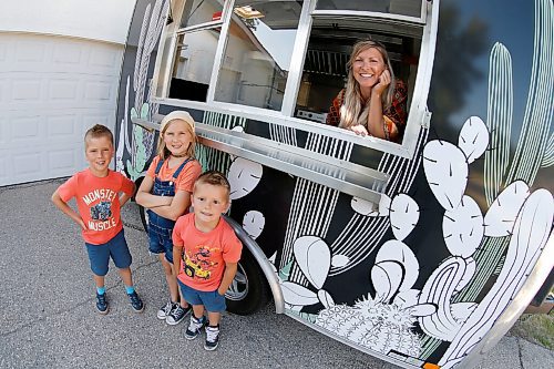 JOHN WOODS / WINNIPEG FREE PRESS
Erin Popoff, a former WestJet pilot laid off because of the pandemic, is photographed with her children Kodiak, 5, Makeiff, 7, and Olive, 9, and her new food truck trailer, Poacht, outside her home in Winnipeg Wednesday, June 30, 2021. Popoff launched the pandemic pivot small business to make up for being let go by WestJet.

Reporter: Durrani