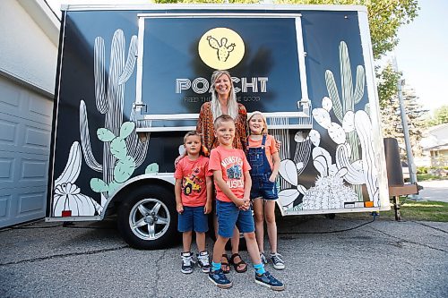 JOHN WOODS / WINNIPEG FREE PRESS
Erin Popoff, a former WestJet pilot laid off because of the pandemic, is photographed with her children Kodiak, 5, Makeiff, 7, and Olive, 9, and her new food truck trailer, Poacht, outside her home in Winnipeg Wednesday, June 30, 2021. Popoff launched the pandemic pivot small business to make up for being let go by WestJet.

Reporter: Durrani