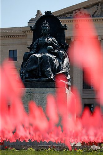 JOHN WOODS / WINNIPEG FREE PRESS
Hundreds of flags are placed at the feet of the statue of Queen Victoria at the Manitoba Legislature as hundreds joined in two marches for the children that have been found on residential school properties throughout Canada in Winnipeg Thursday, July 1, 2021. 

Reporter: ?