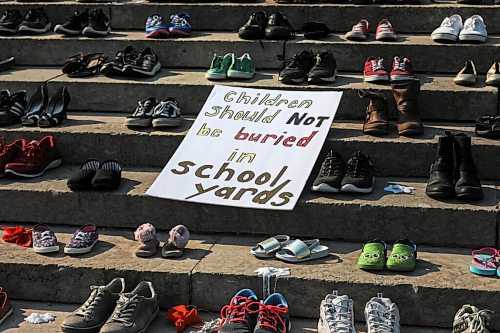 RUTH BONNEVILLE / WINNIPEG FREE PRESS

Local - Leg Statue down

Photo of sign "Children should not be buried in school yards" surrounded with children's shoes, on the steps of the Manitoba Legislative Building.

July 02, 2021