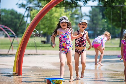 MIKAELA MACKENZIE / WINNIPEG FREE PRESS

Eloise Moore (six, left) and Sula Fiorante (six) play together at the Provencher Park splash pad in Winnipeg on Friday, July 2, 2021. For Cody story.
Winnipeg Free Press 2021.