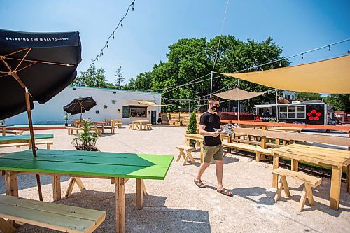 MIKAELA MACKENZIE / WINNIPEG FREE PRESS

Scott Angus walks drinks and food back to his table at Garden 955, a new beer garden at 955 Portage Avenue, in Winnipeg on Friday, July 2, 2021. For Ben Sigurdson story.
Winnipeg Free Press 2021.