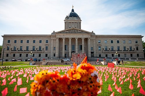Daniel Crump / Winnipeg Free Press. Hundreds of little orange flags wave near the empty stone base where a large statue of queen Victoria once stood in front of the Manitoba legislature. The statue was pulled down by indigenous protestors following a march honouring the survivors and victims of residential schools. July 3, 2021.