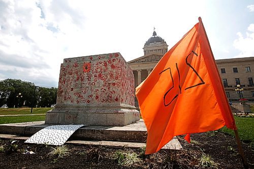 JOHN WOODS / WINNIPEG FREE PRESS
Painted red hands and flags surround a pedestal where the statue of a former colonizer, Queen Victoria, once stood in Winnipeg Sunday, July 4, 2021. The statue was pulled down July 1.

Reporter: ?