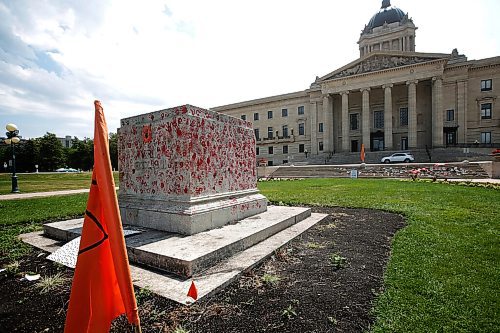 JOHN WOODS / WINNIPEG FREE PRESS
Painted red hands and flags surround a pedestal where the statue of a former colonizer, Queen Victoria, once stood in Winnipeg Sunday, July 4, 2021. The statue was pulled down July 1.

Reporter: ?