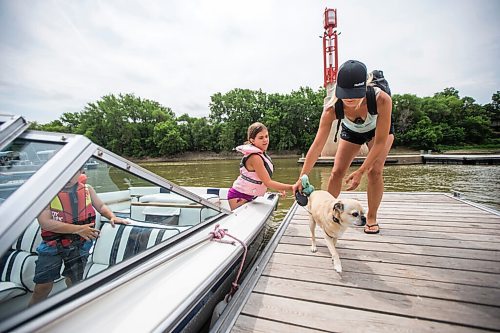 MIKAELA MACKENZIE / WINNIPEG FREE PRESS

Chloe Marasco (eight) hands her mom, Leanne Marasco, their dog Reese as her little brother, Cole Marasco (three) watches) while boarding the dock at The Forks in Winnipeg on Monday, July 5, 2021. Standup.
Winnipeg Free Press 2021.