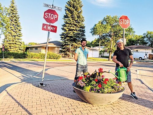Canstar Community News Resident volunteers Bryce Weedmark (left) and Chris Turyk are tending to the new Garden City neighbourhood planter.