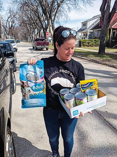 Canstar Community News Sara Anema, Winnipeg branch manager of the Animal Food Bank, gets ready to deliver pet food to some of the 200 Winnipeg families who need its services each month.