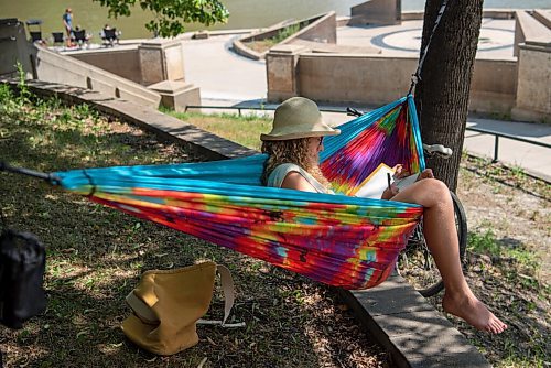 ALEX LUPUL / WINNIPEG FREE PRESS  

Erika Bormann sits in the shade in her hammock, behind the Manitoba Legislative Building in  Winnipeg on Monday, July 5, 2021.