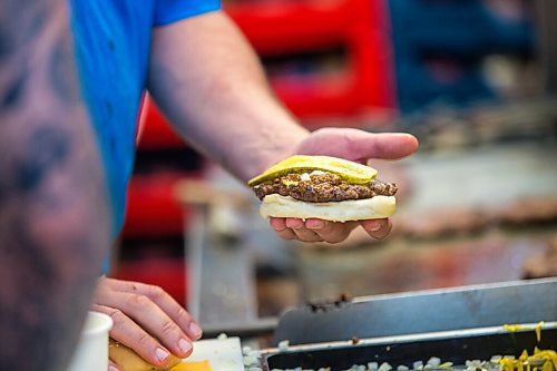 MIKAELA MACKENZIE / WINNIPEG FREE PRESS

Ray McDiarmid makes burgers at the Dairi-Wip Drive In, one of the more iconic burger joints in town, in Winnipeg on Tuesday, July 6, 2021. For Dave Sanderson story.
Winnipeg Free Press 2021.