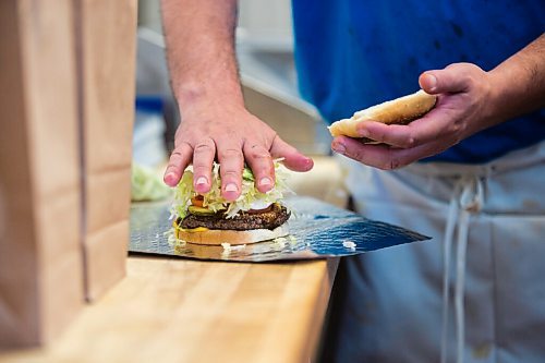 MIKAELA MACKENZIE / WINNIPEG FREE PRESS

Ray McDiarmid makes burgers at the Dairi-Wip Drive In, one of the more iconic burger joints in town, in Winnipeg on Tuesday, July 6, 2021. For Dave Sanderson story.
Winnipeg Free Press 2021.