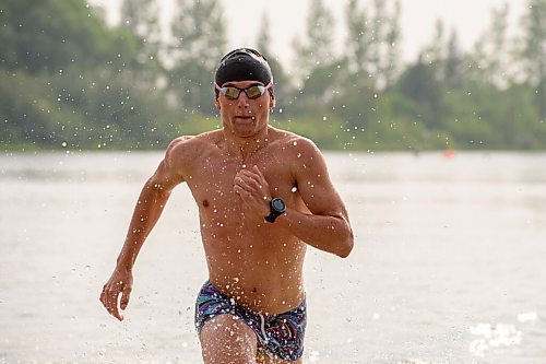 MIKE SUDOMA / WINNIPEG FREE PRESS
Triathlete, Blake Harris, runs out of the water after finishing a swim lap during Triathlon Manitoba practice in Birds Hill Park Tuesday evening
July 6, 2021