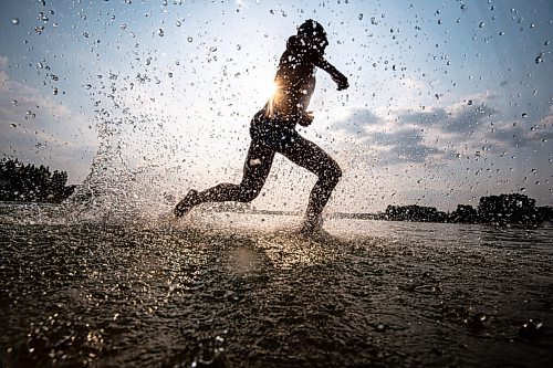 MIKE SUDOMA / WINNIPEG FREE PRESS
Triathlete, Blake Harris, runs out of the water after finishing a swim lap during Triathlon Manitoba practice in Birds Hill Park Tuesday evening
July 6, 2021